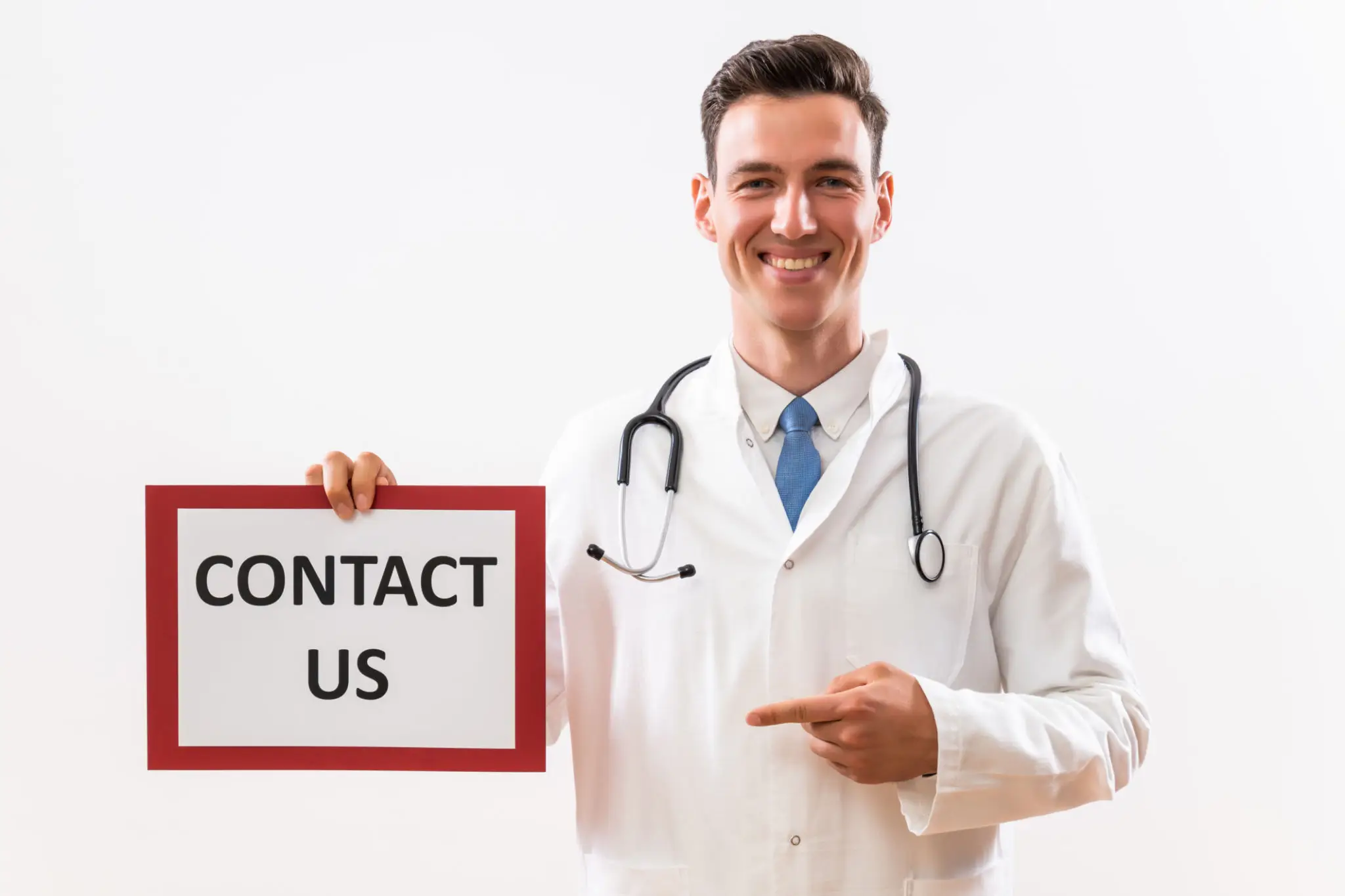 Smiling doctor holding a sign that says 'CONTACT US'.