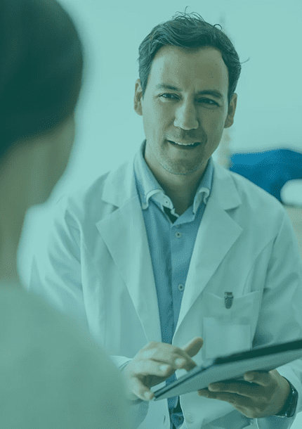 A doctor attentively listening to a patient in a clinical setting.