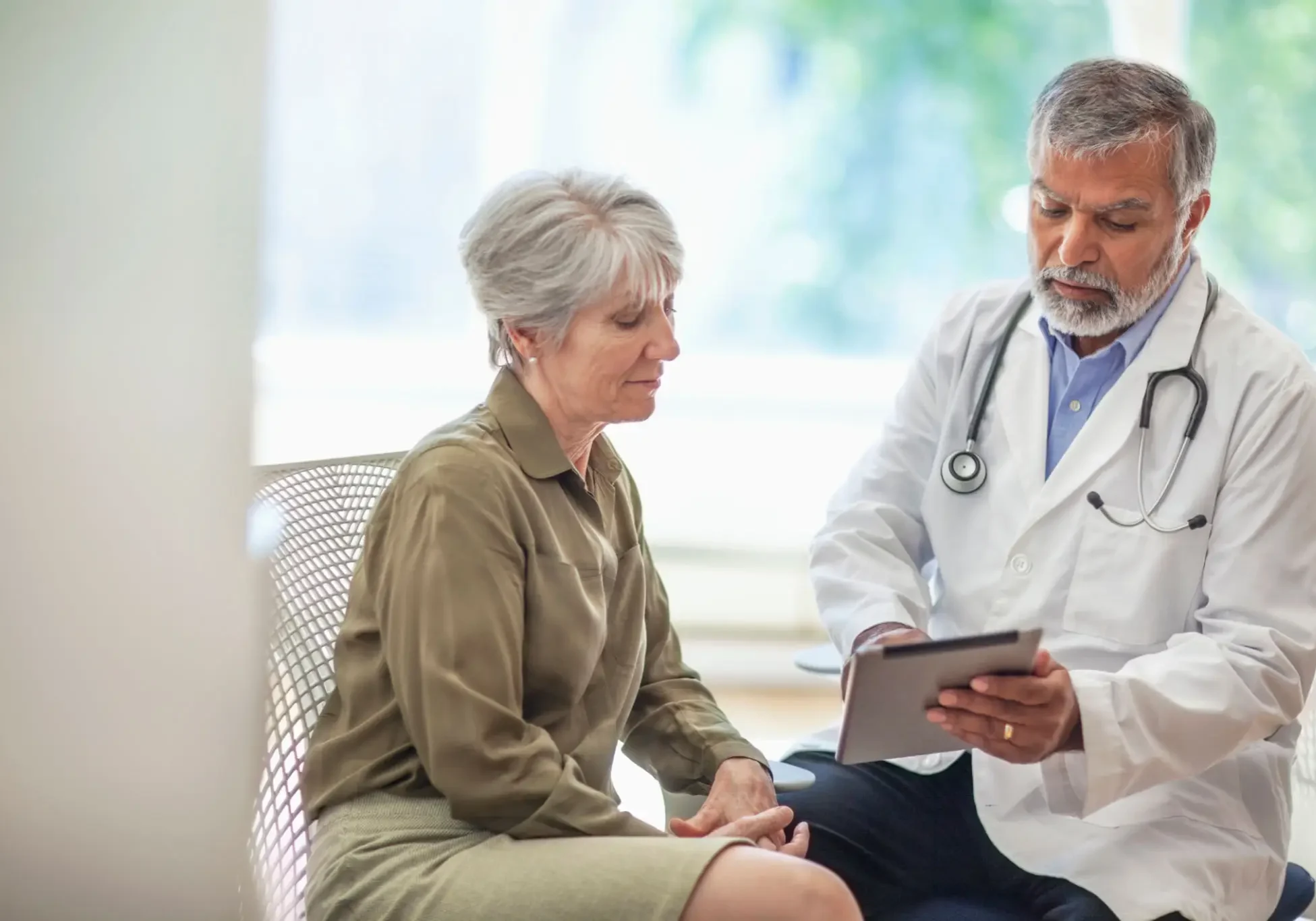 Doctor discussing medical results with a female patient in a clinic.