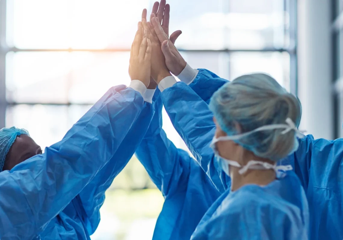 Medical team celebrating with high five