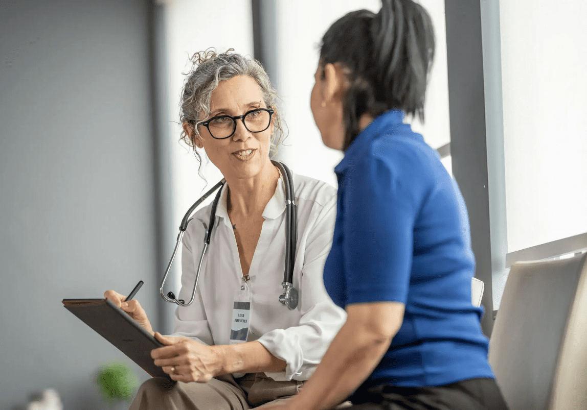 Doctor attentively listening to a patient during consultation.